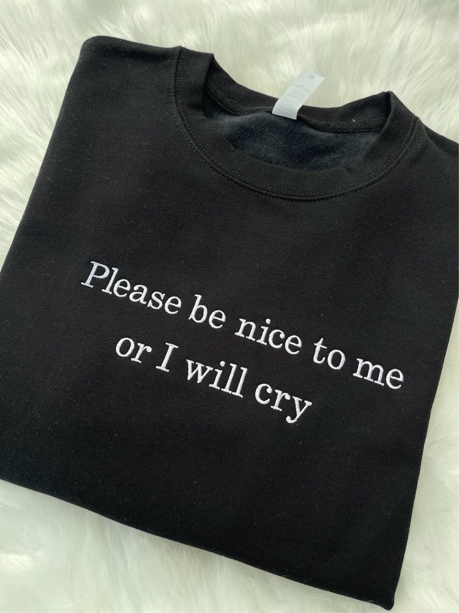 Black sweatshirt with "please be nice to me or I will cry" embroidery