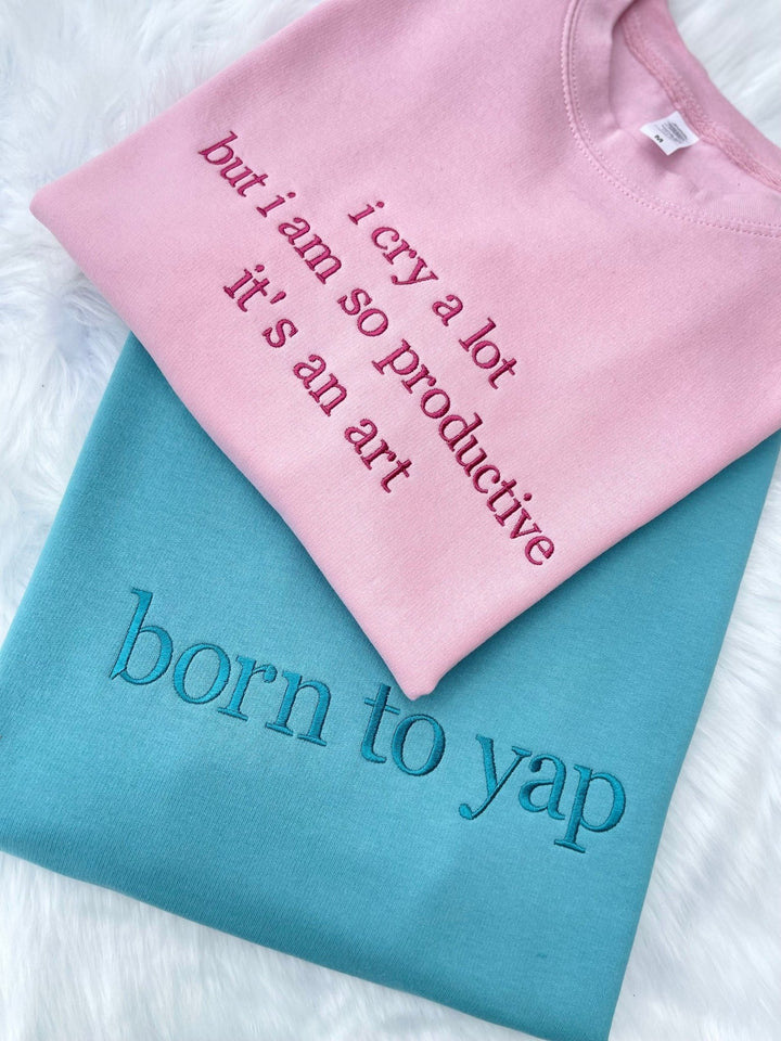 Pink and blue sweatshirts with custom slogan embroidery