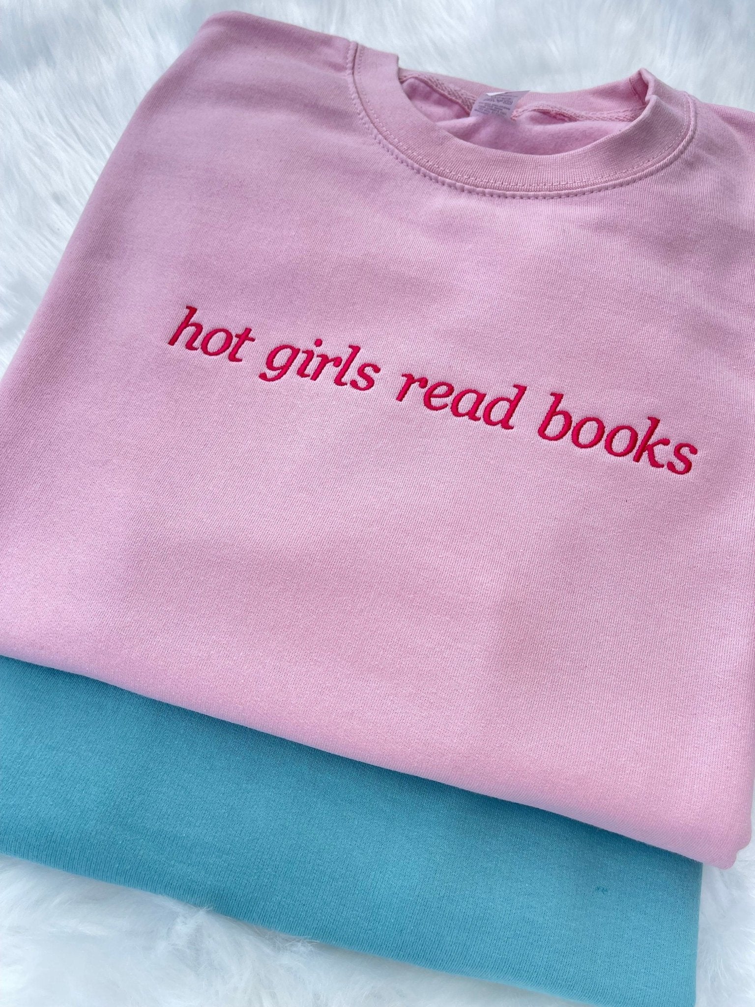 Pink sweatshirt with "hot girls read books" embroidered slogan