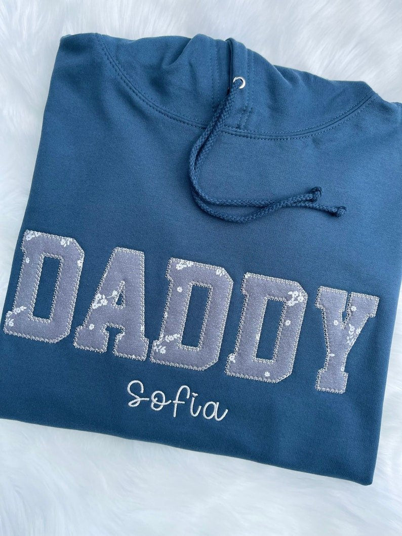 Blue sweatshirt with appliqué “Daddy” in bold fabric design