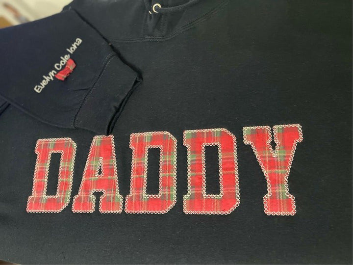 Black sweatshirt with appliqué “Daddy” in red check fabric design