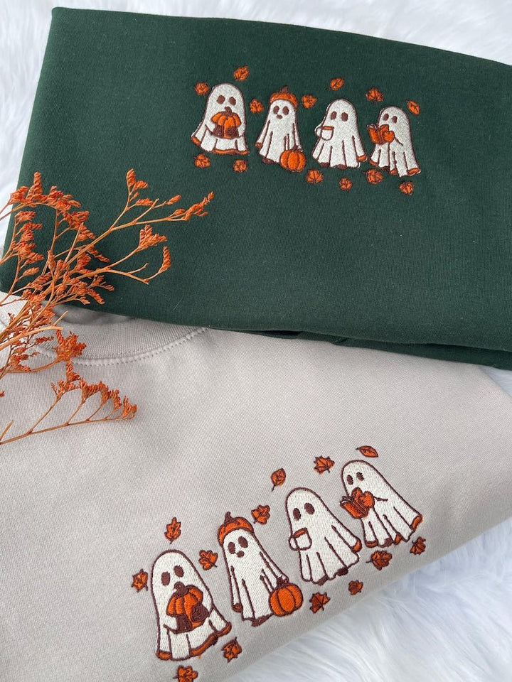 Beige and green embroidered Halloween ghost sweatshirts styled with autumn decor