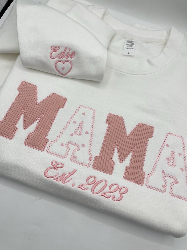 White sweatshirt with pink applique “MAMA” letters and Est. date embroidery