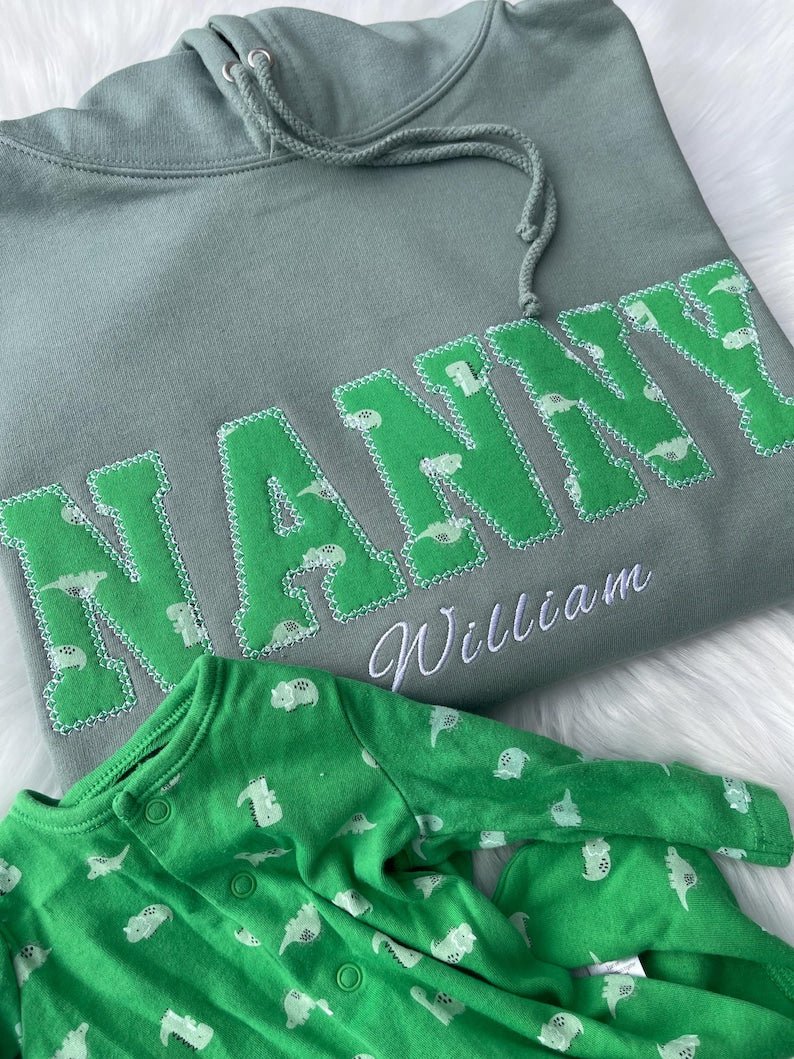 Green hoodie with applique “NANNY” letters made from babysuit personalised embroidery