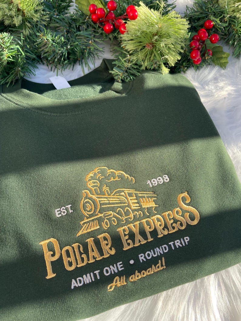 Polar Express sweatshirt in green with gold embroidery featuring Christmas decor