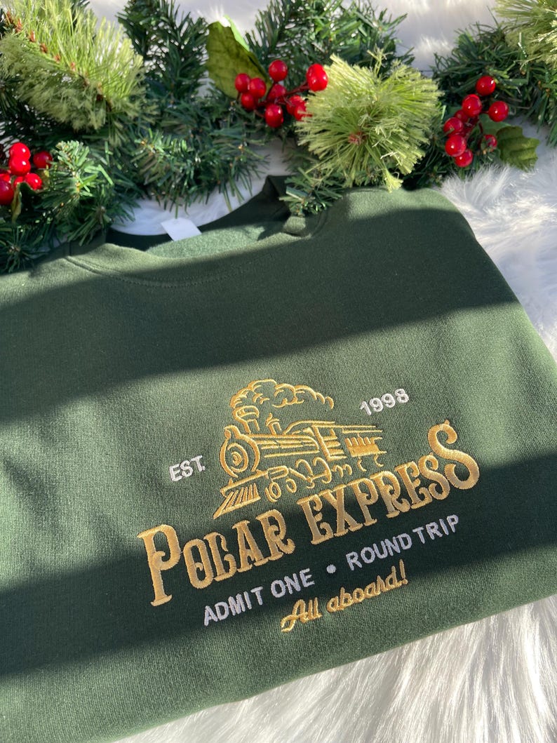 Polar Express sweatshirt in green with gold embroidery, styled for Christmas