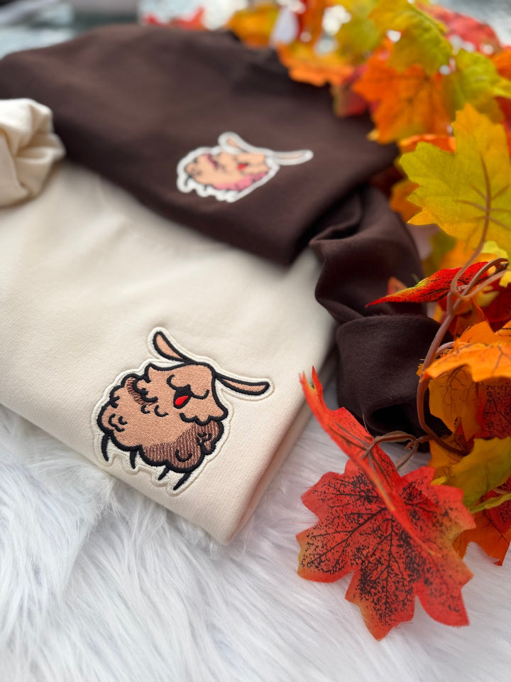 Milkshake and brown Silksong Flea embroidered sweatshirts styled with autumn leaves