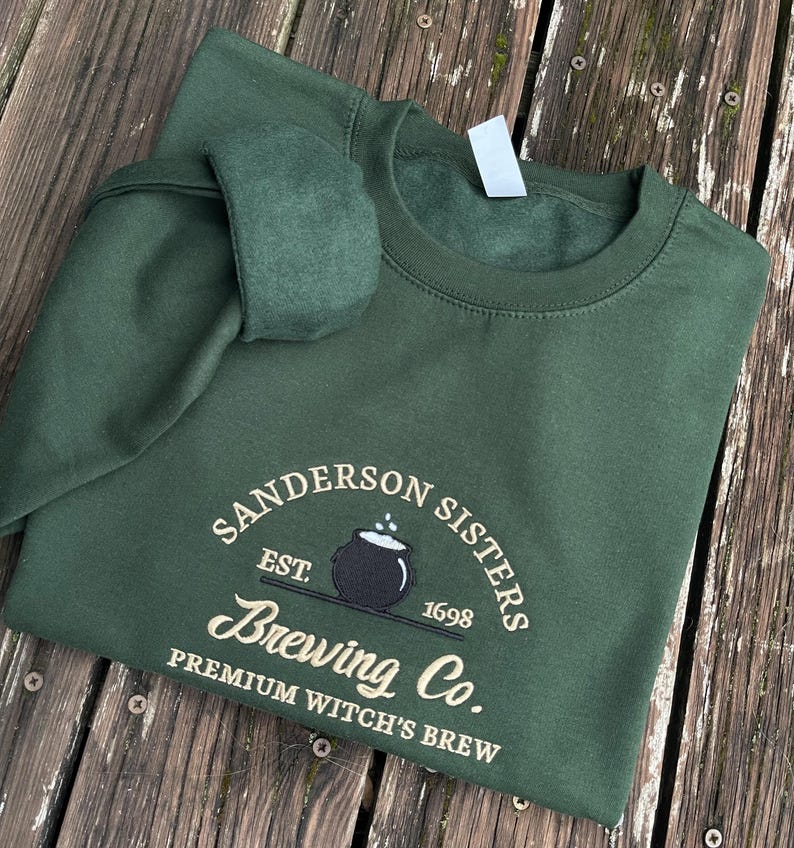 Green Sanderson Sisters Brewing Co embroidered sweatshirt flatlay